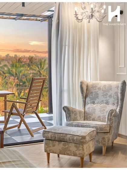 A quiet moment of relaxation, with a comfortable armchair and ottoman perfectly positioned to enjoy the view from the villa's deck.