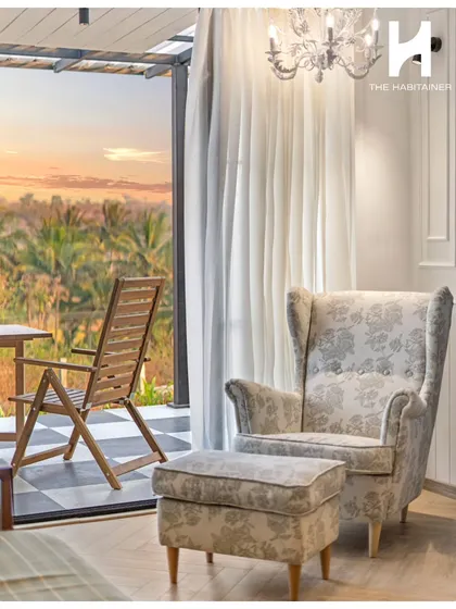 A quiet moment of relaxation, with a comfortable armchair and ottoman perfectly positioned to enjoy the view from the villa's deck.