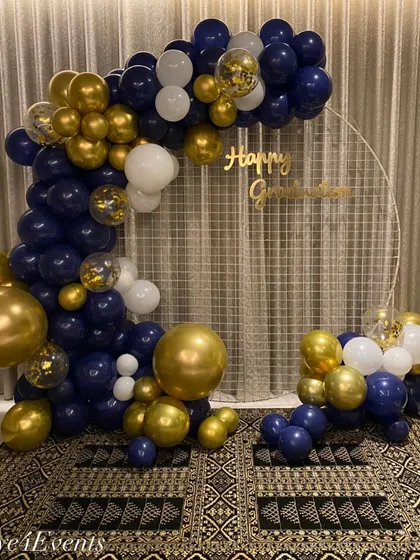 To celebrate a major academic achievement, I designed this stylish "Happy Graduation" photo corner. It features a circular mesh backdrop adorned with a sophisticated balloon arch in navy blue, gold, and white, creating a perfect spot for memorable photos.