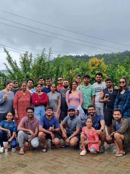 A large group photo in front of a homestay, with everyone looking ready for the day. This shows the scale of our community and the start of a great day.