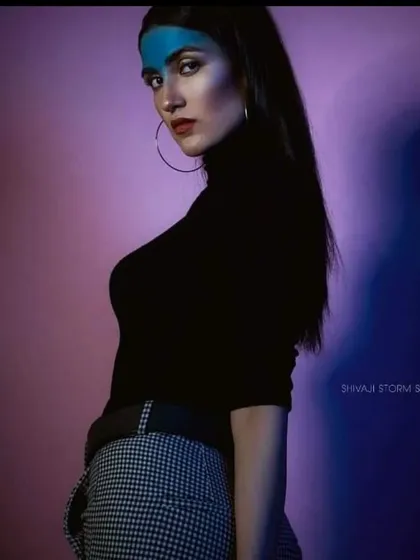 This editorial makeup features a block of bold blue pigment across the forehead. It's a conceptual look that plays with color placement for a modern, high-fashion effect.