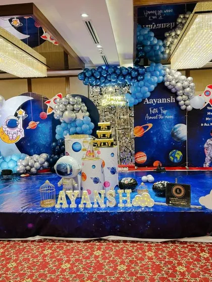 For the little explorer, I design out-of-this-world space themes. This setup features a floor-to-ceiling galaxy backdrop, custom astronaut and rocket cutouts, and a balloon arch in cosmic blues and silvers, making the birthday boy or girl the star of their own universe.