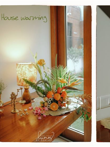 A close-up of a floral arrangement that includes oranges and other fruits, adding a fresh and whimsical touch.