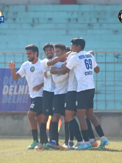 The team celebrates a goal together, a perfect picture of unity and shared joy.