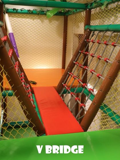 The V-bridge is another fun element in our play structure. It challenges kids' balance as they navigate the padded walkway between two sections of the gym.