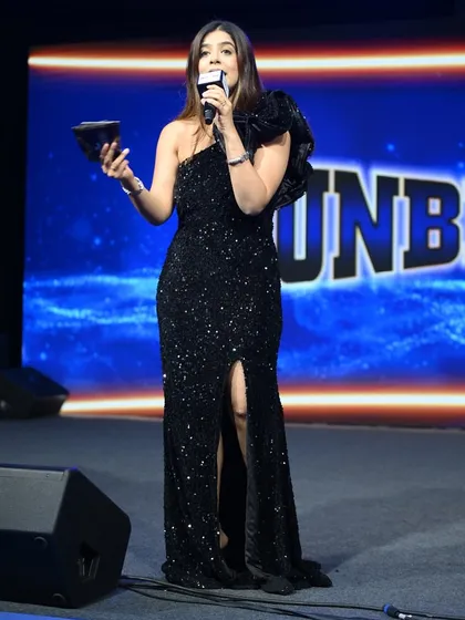 Holding an award, ready to announce the next winner at the Mankind Pharma event. Making these moments special is what I do best.
