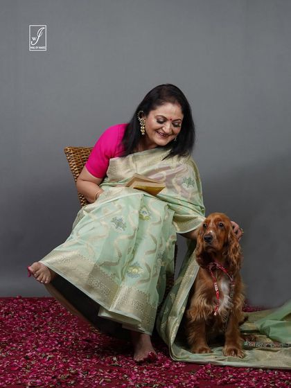 Adding a personal and charming touch to a traditional saree shoot with the inclusion of a beloved pet.
