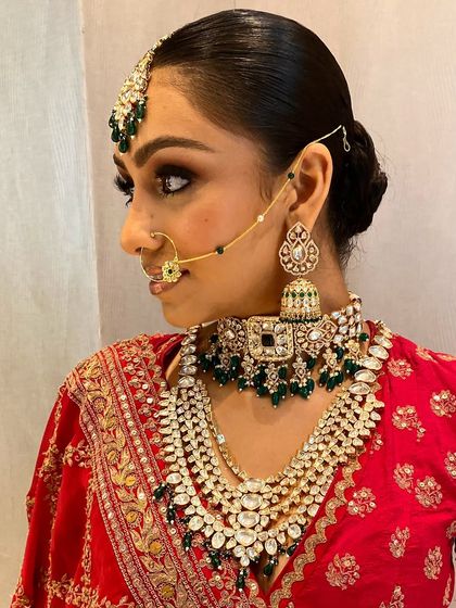 The side profile highlights the craftsmanship of the jhumkas and the delicate chain of the nath. Every piece in our rental sets is checked for quality.