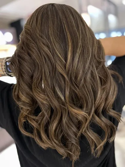 A beautiful warm-to-cool hair color change. I gave her a new textured haircut and added cool beige blonde highlights to create this fresh, updated style.