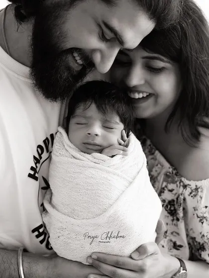 There's a special kind of magic in the first family portrait. This black and white image focuses on the pure joy and connection between new parents and their baby, a timeless memory of when your family grew.
