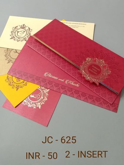 A bright red invitation with a gold foil emblem. This affordable set includes colorful inserts, making it a perfect choice for a festive and traditional wedding.