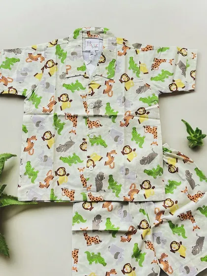 Get ready for a jungle adventure with this adorable animal print pajama set. Featuring friendly monkeys, giraffes, and crocodiles, this 100% cotton outfit is designed for wild dreams and cozy nights.