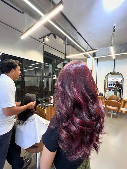 A gorgeous magenta hair color, achieved without using bleach. This shows that you can get vibrant results on dark hair with the right professional products.