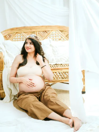 A joyful and bright portrait from a boho-chic maternity session. This image radiates happiness and calm confidence.