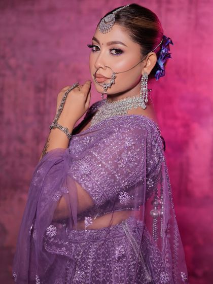 A modern bridal look featuring a lavender lehenga paired with a stunning diamond and silver jewellery set. This shows how you can rent contemporary jewellery for a unique look.