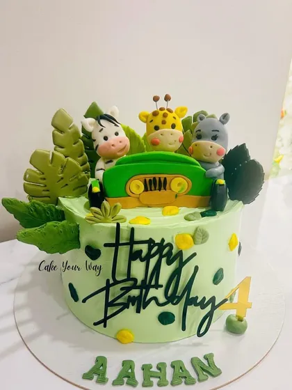 A wild jungle safari cake for Aahan's 4th birthday, featuring fondant animals in a jeep.