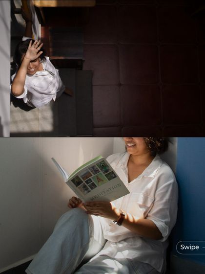 A resident finds a quiet, sunlit corner to read, demonstrating how even small, transitional spaces can be designed for comfort and tranquility.