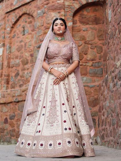 A full view of the pastel lehenga, showcasing its beautiful flare and the intricate patterns on the skirt.