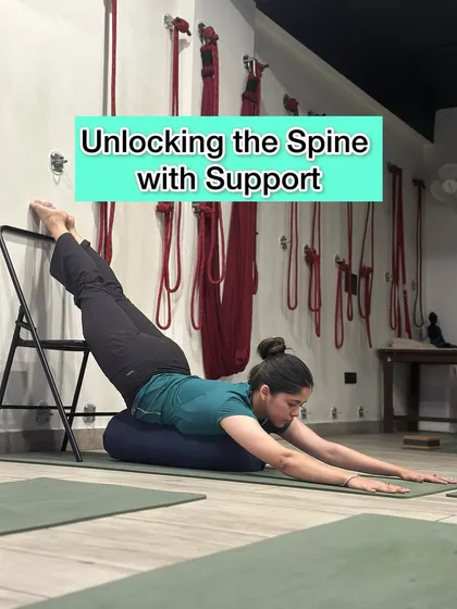 Unlocking the spine requires both effort and support. This supported backbend using a bolster and chair creates traction and space in the vertebral column, which is highly therapeutic for spinal health and flexibility.