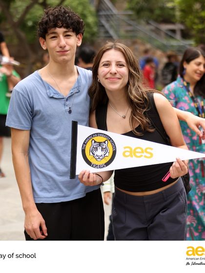 Students proudly display an AES Tigers pennant on the last day of school. School spirit and a sense of belonging are things our students carry with them long after the school year ends.