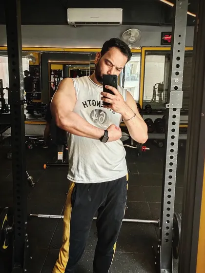 A reminder to push yourself because no one else will do it for you. A quick bicep flex in the gym mirror.