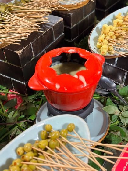 A cheese fondue station is a perfect interactive element for a relaxed yet elegant event. We serve it with a variety of dippables, from olives to baby corn.