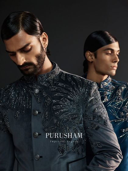 Where every stitch weaves a story of brilliance. The intricate, feather-like embroidery on this grey jacket is a hallmark of my craft, designed for a discerning eye.