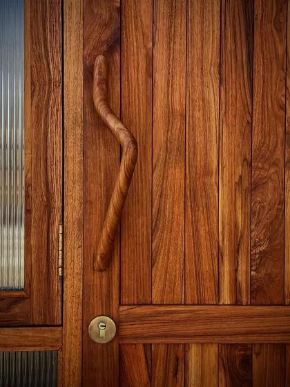A custom-designed wooden door handle with a beautiful, ergonomic curve. We believe that the details you touch every day should be thoughtfully designed and exquisitely crafted.