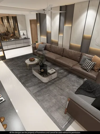 An overhead view of a spacious living room. The large leather sectional, plush area rug, and marble-topped coffee tables create a luxurious and comfortable gathering space.
