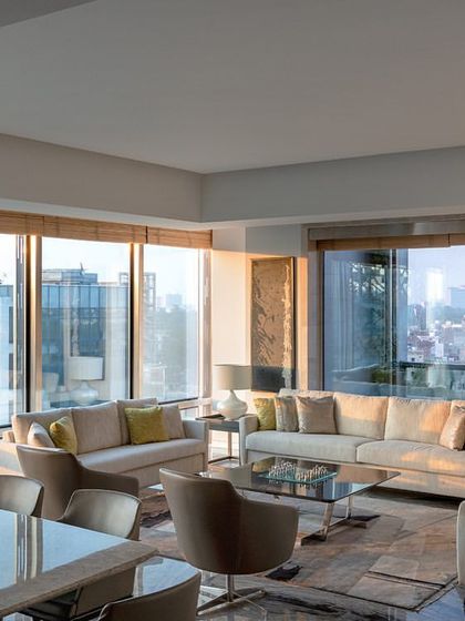 A visitor's lounge on the top floor of the Stainless Steel Office. The space is designed with comfortable seating and large windows that provide expansive city views, offering a luxurious waiting area for guests.