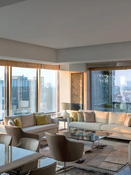 A visitor's lounge on the top floor of the Stainless Steel Office. The space is designed with comfortable seating and large windows that provide expansive city views, offering a luxurious waiting area for guests.