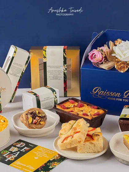 A full spread of festive desserts and gift boxes. This shot is designed to showcase an entire collection, perfect for a brand's Diwali catalogue.