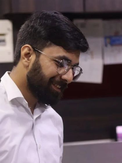 A candid smile in the office. Despite the serious nature of my work, maintaining a positive and approachable attitude is important to me.