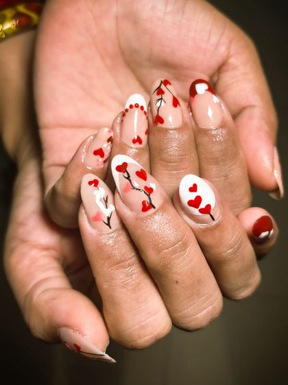 A sweet and romantic nail art design featuring tiny hearts, perfect for Valentine's Day or any day you want to show some love.