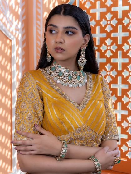 A side profile view of the mint green bridal set, highlighting the matching earrings and bangles. This shows how the entire ensemble comes together for a complete and polished look.