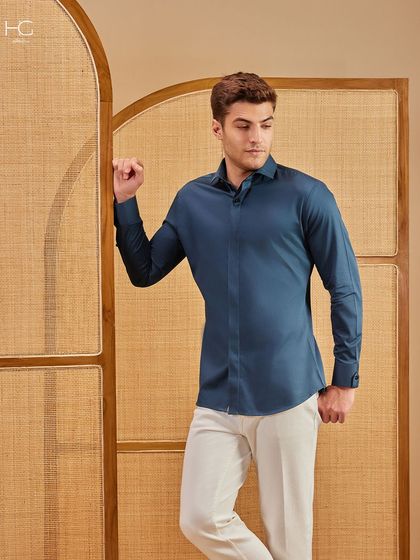Clean contrast, crisp intent. This deep teal shirt paired with white trousers is where weekend ease meets weekday polish, a perfect smart-casual combination.