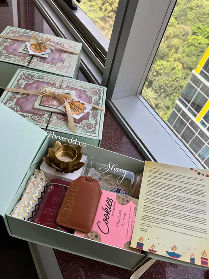 An open view of the stunning personalized hamper for The Belgian Waffle Co., showcasing the thoughtful curation of items including a custom-named bottle and a personal letter.