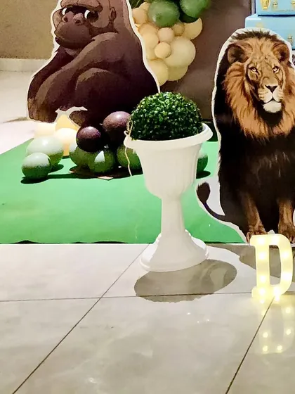 A life-sized gorilla cutout and a lion cutout stand guard, adding to the wild atmosphere of the jungle theme.