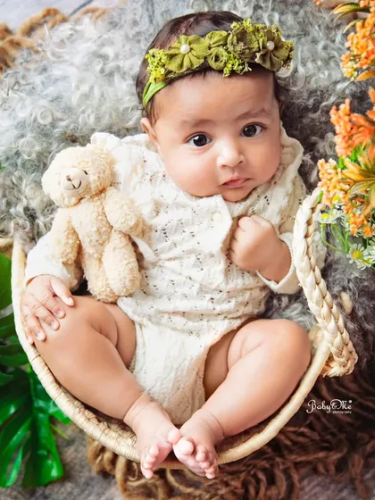 A beautiful, direct gaze from this sweet baby girl. Her expressive eyes are the heart of this simple and stunning portrait.