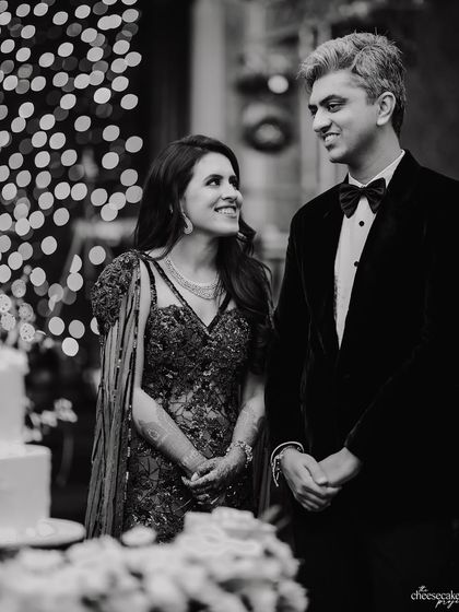 A beautiful candid of the couple listening to speeches, their expressions filled with love and gratitude.