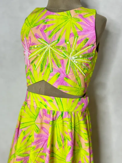 A close-up of the neon leaf print choli, showing the delicate sequin and thread embroidery that adds a touch of sparkle.