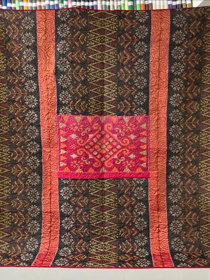 We specialize in transforming cherished sarees into beautiful, functional memory quilts. This piece preserves the intricate patterns and rich colors of a mother's saree, creating a reversible heirloom that can be passed down through generations.