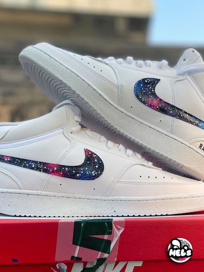 A product shot of the matching galaxy high-tops, displayed on their Nike box.