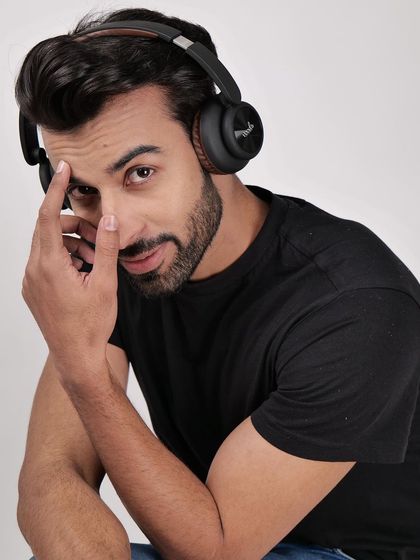 A model wearing headphones and looking at the camera. This engaging shot is great for website banners and social media, creating a connection with the viewer.