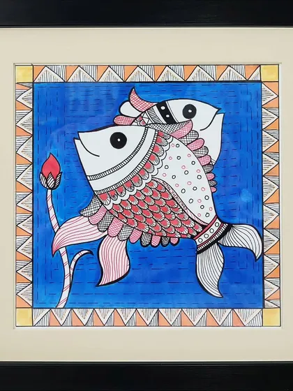 A beautiful example of Madhubani folk art created by one of our associated artists. This piece, featuring two fish and a lotus bud, uses the intricate lines, patterns, and vibrant colors characteristic of this traditional Indian painting style.