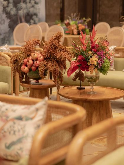 A seating area at the naming ceremony, with beautiful floral arrangements on the tables.