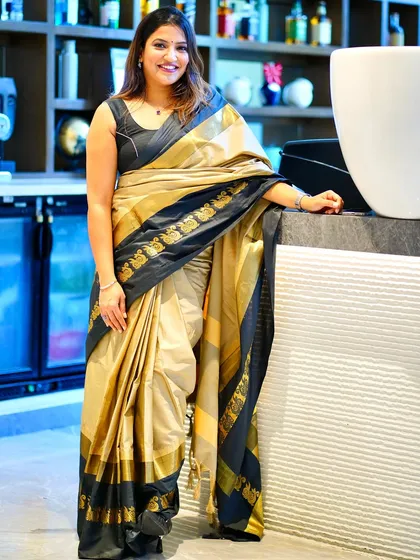 Posing in a beautiful gold and black saree. I love how a saree can be both powerful and graceful.