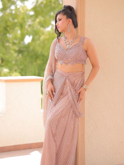 A full-length shot showing how the modern updo complements the contemporary design of her outfit. This is a perfect example of matching the hair to the overall vibe of the look.