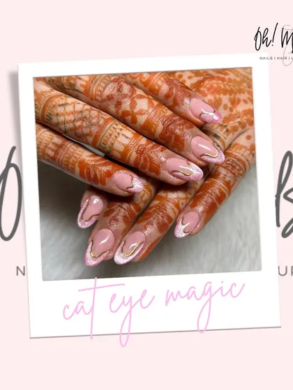A beautiful design for a special occasion, pairing cat eye nails with intricate henna. The pink magnetic polish and gold chrome swirls create a mesmerizing effect.