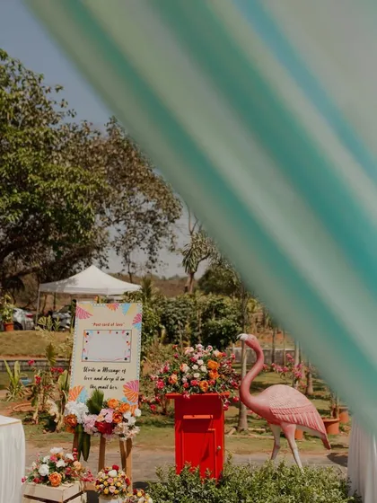 A playful corner at a carnival-themed Mehendi, featuring a pink flamingo and a mailbox for guests to leave messages for the couple.